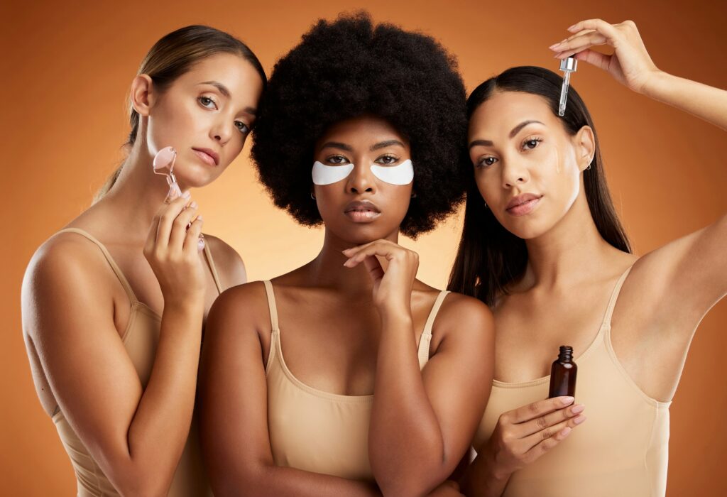 Beauty, diversity and makeup with model woman friends in studio on a brown background for skincare