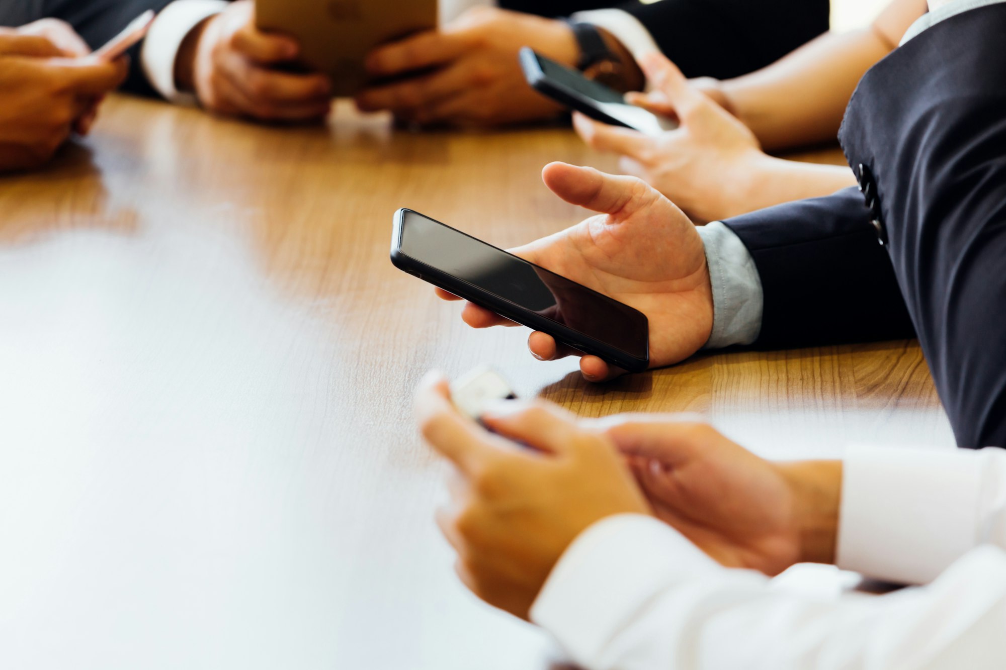 Businessman using phone while waiting for the app or website to load in the office