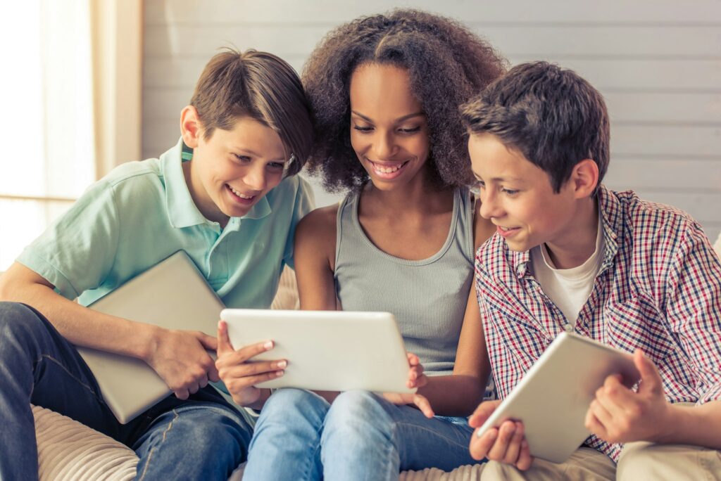 Teenagers with gadgets at home