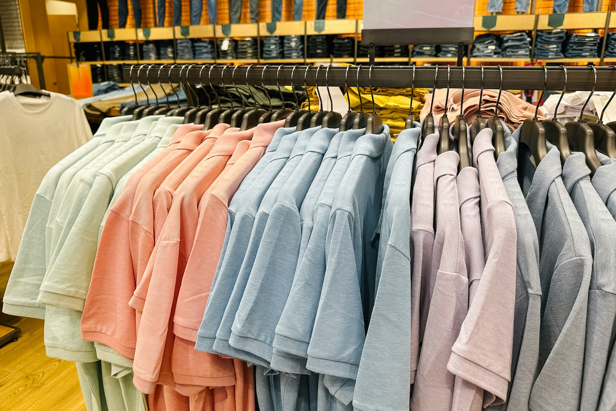 T-shirts are Hanging on a Hanger in a Clothing Store