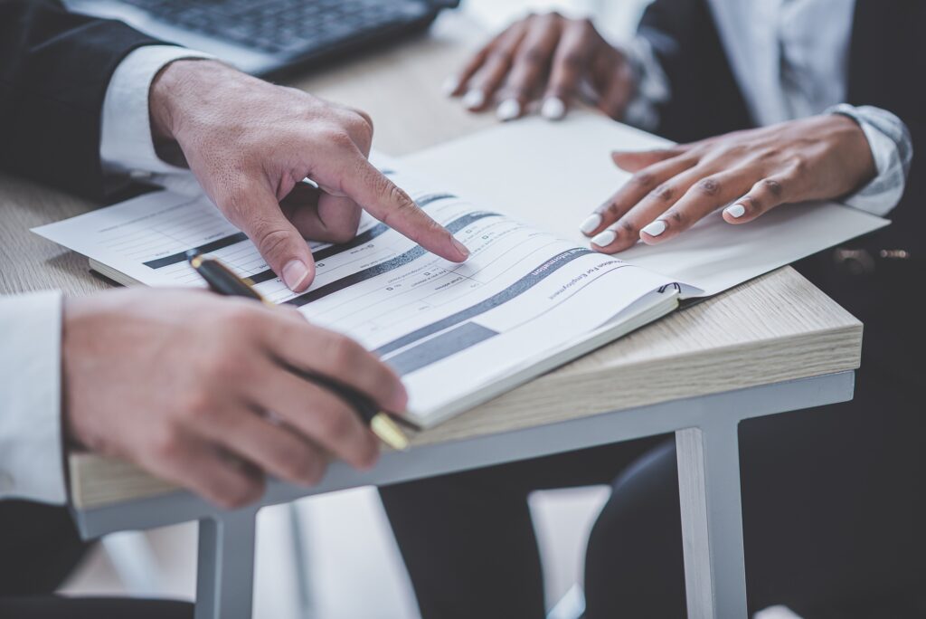 Business man talks to an African businesswoman or partner about company profile