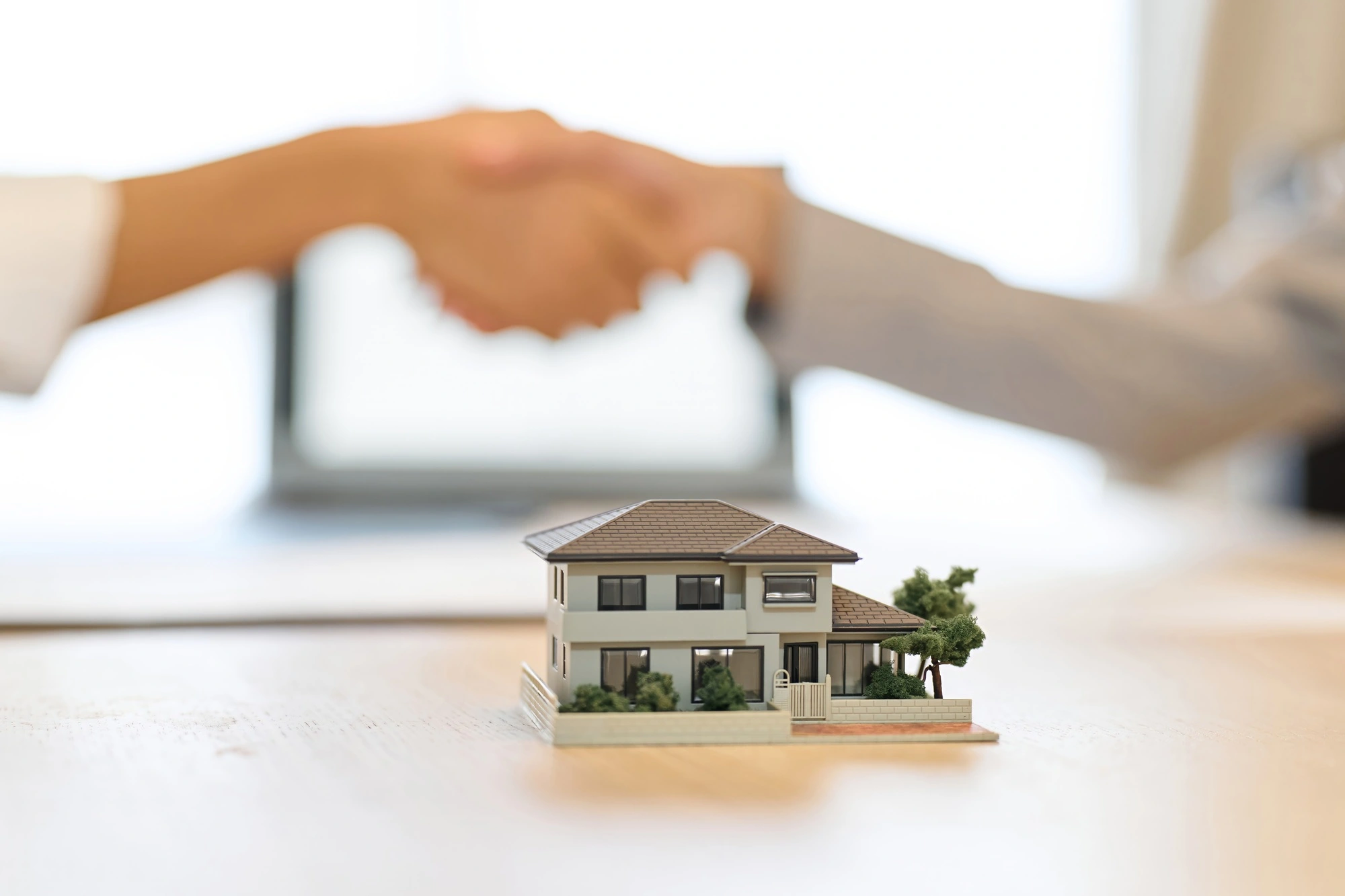 A man and a woman shaking hands during a real estate contract