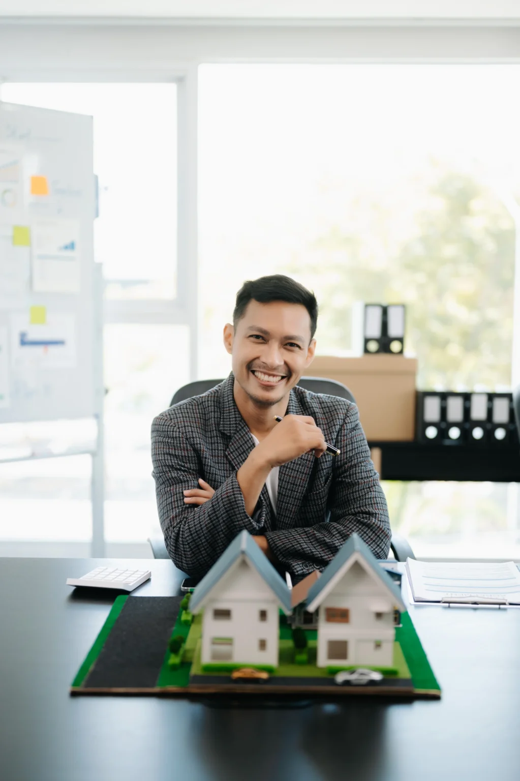 Young real estate agent worker working with laptop and tablet at