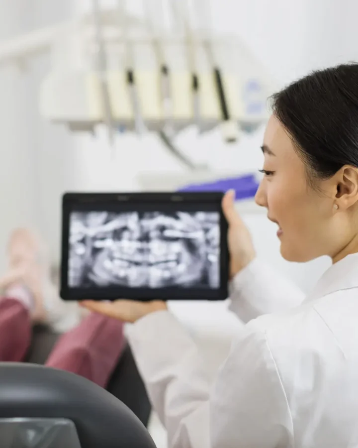 back-view-of-smiling-happy-caucasian-child-girl-visiting-dentist-sitting-in-dental-chair (1)